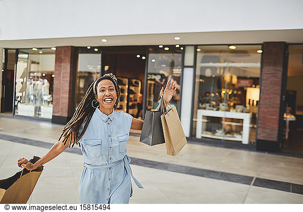 Portrait excited woman shopping in mall