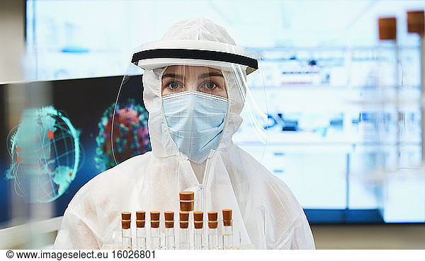 Portrait female scientist in clean suit studying coronavirus vaccine