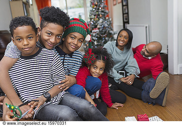 Portrait happy family celebrating Christmas in living room