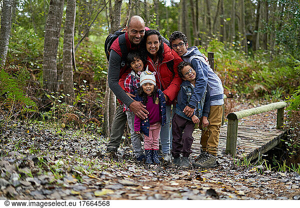 Portrait happy family hiking in woods