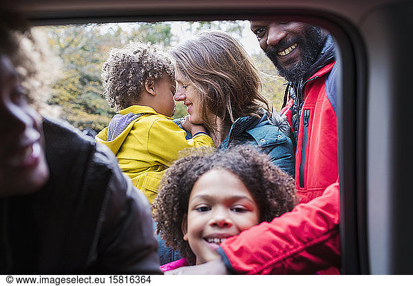 Portrait happy family outside car window