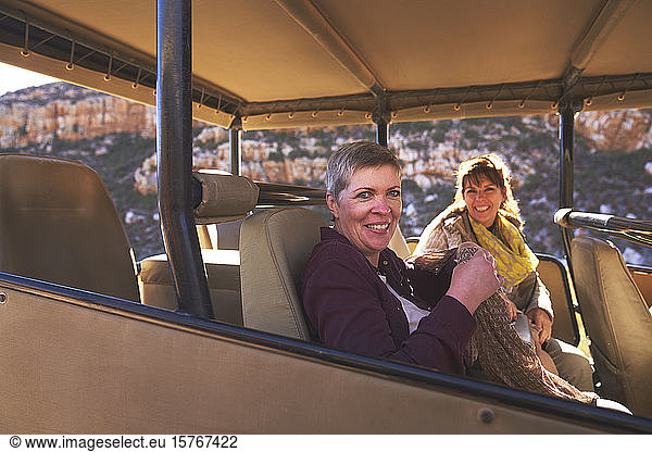 Portrait happy mature women friends in safari off-road vehicle