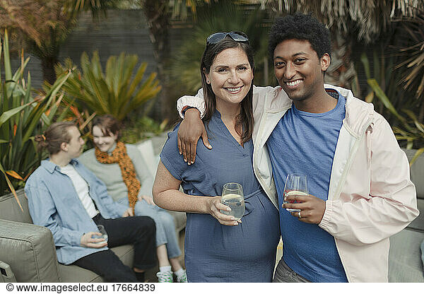 Portrait happy pregnant couple on patio