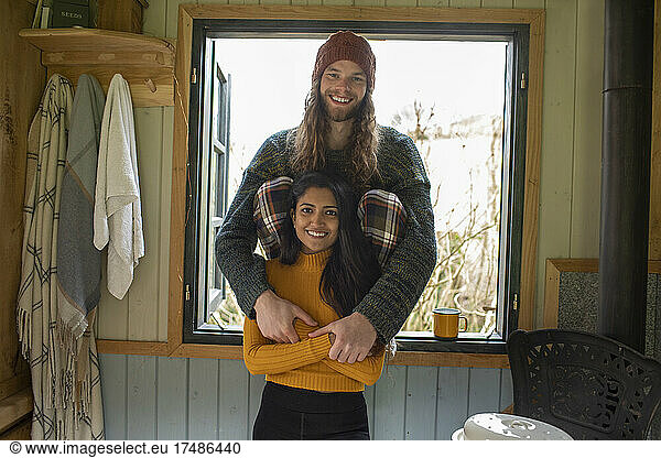 Portrait happy young couple in cabin window