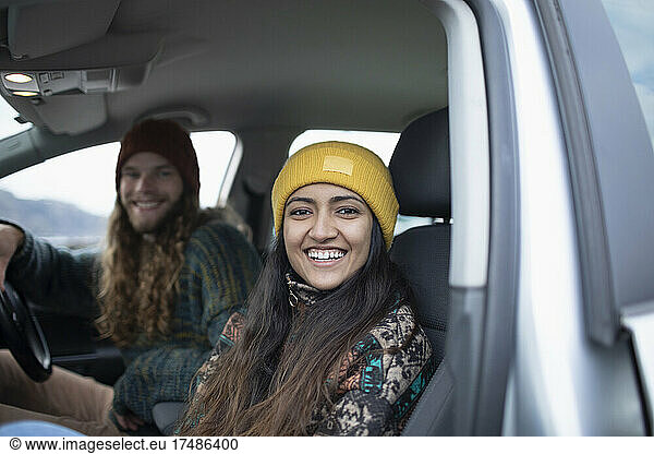 Portrait happy young couple on road trip in car
