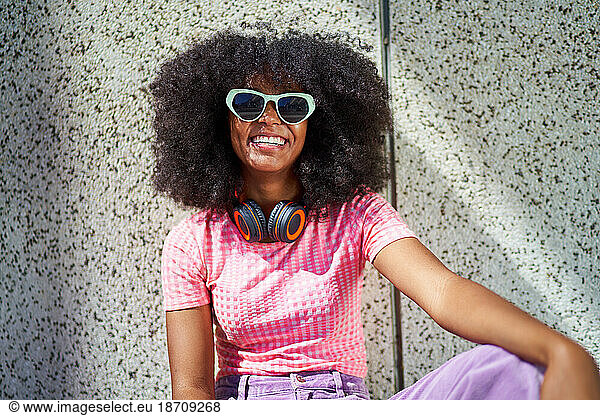 Portrait happy young woman in sunglasses with headphones