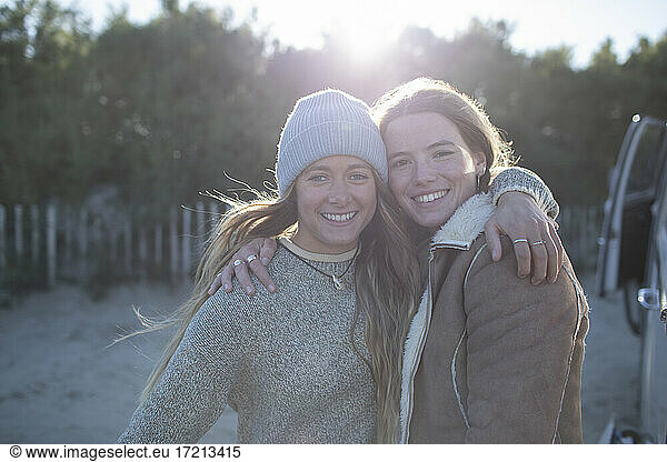 Portrait happy young women friends hugging outdoors