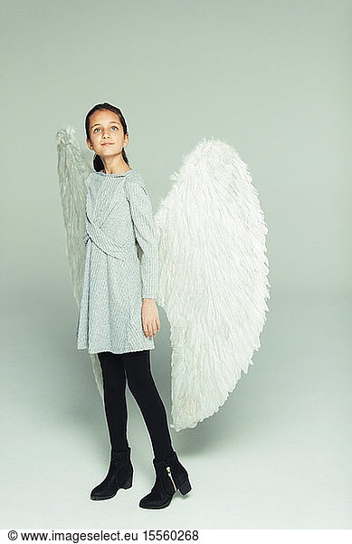 Portrait hopeful  ambitious girl wearing angel wings