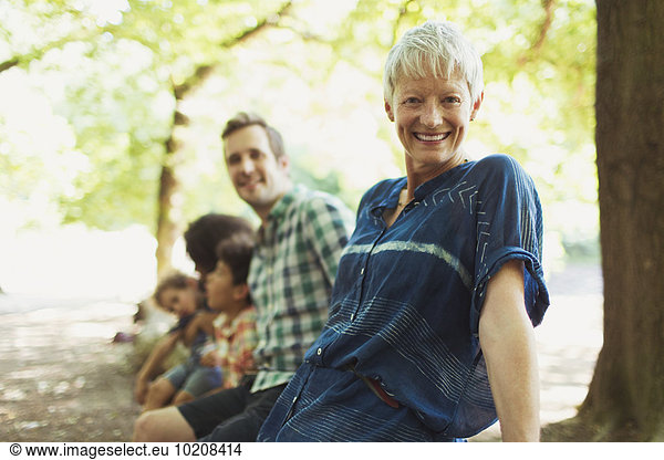 Portrait lächelnde Mehrgenerationen-Familie im Wald