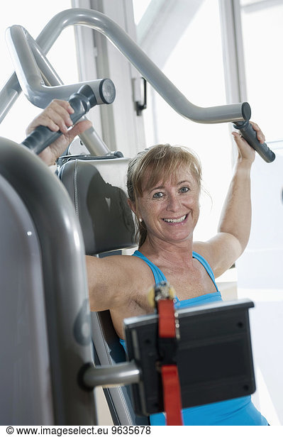 Portrait mature woman fitness studio smiling happy