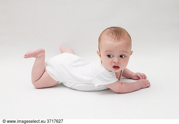 Portrait of a baby boy lying on his front