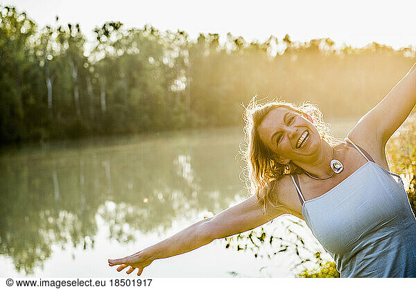 Portrait of a beautiful woman laughing hysterically by river  Germany  Bavaria