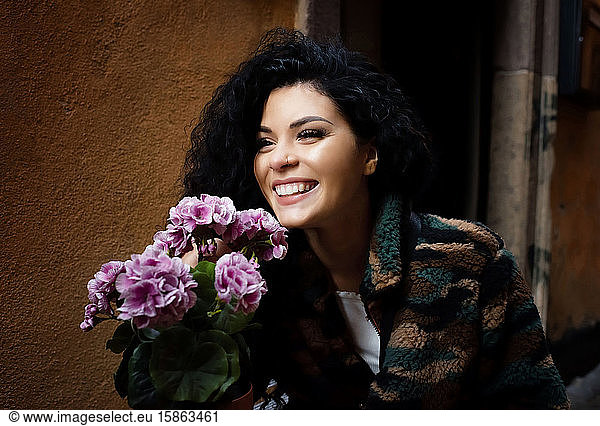 portrait of a beautiful woman smiling holding flowers
