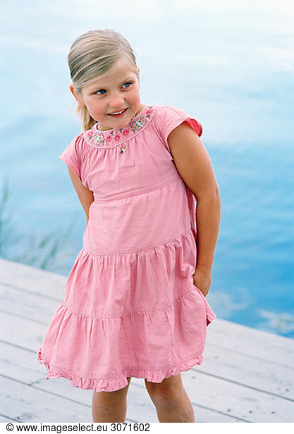 Portrait of a blond girl wearing a pink dress Sweden.