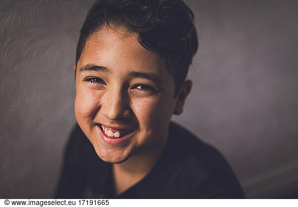 Portrait of a boy smiling at the camera.
