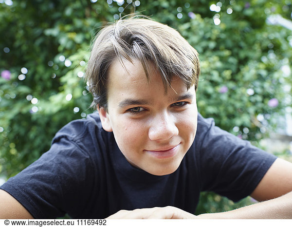 Portrait of a boy with brown hair and eyes  looking at camera.
