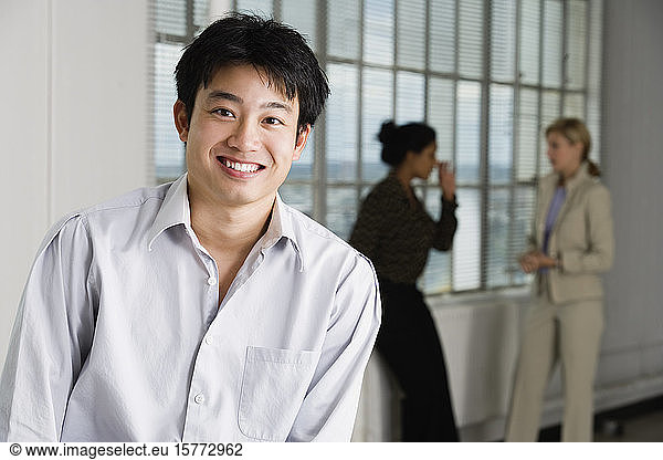 Portrait of a business man with business women in background.
