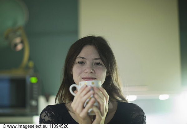 Portrait of a businesswoman having a cup of coffee in an office
