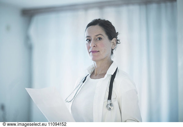 Portrait of a confident female doctor holding a medical report