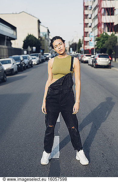 Portrait of a confident stylish young woman standing on the street in the city