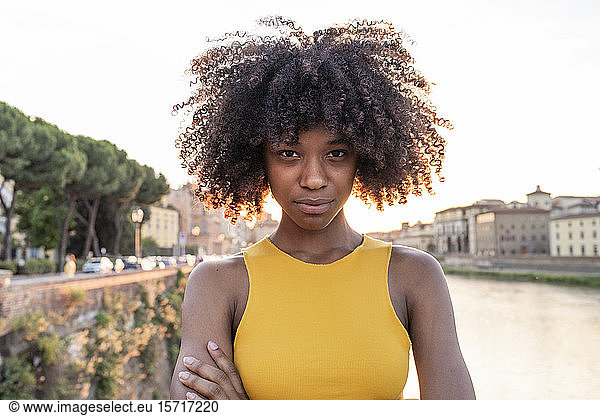 Portrait of a confident young woman at river Arno at sunset  Florence  Italy