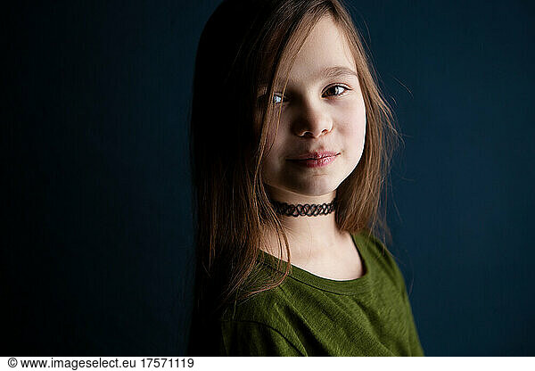 Portrait of a cute little 9 year old girl on dark background??®