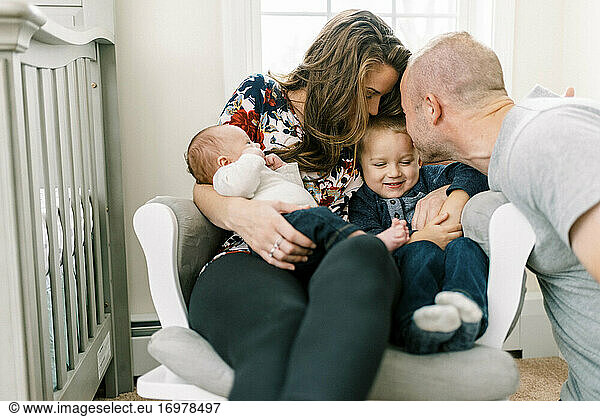 Portrait of a family at home with a newborn baby and a toddler