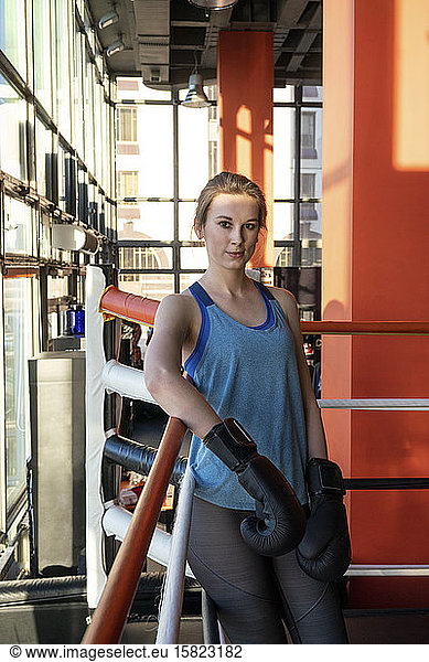 Portrait of a female boxer in gym