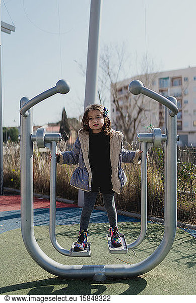 Portrait of a four-year-old girl in a daytime park with a jacket