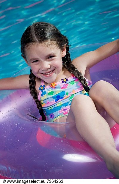 Portrait of a girl sitting in an inner tube