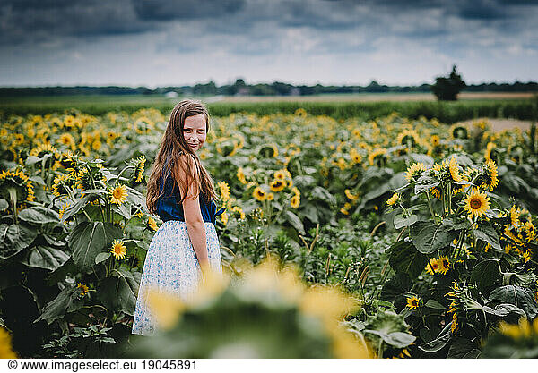 Portrait of a Girl Smiling in a Sunflower Field