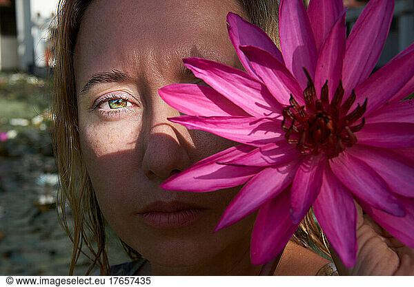 portrait of a girl with a flower on half of her face