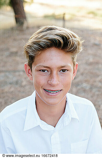 Portrait Of A Handsome Teen Boy With Brown Eyes And Braces