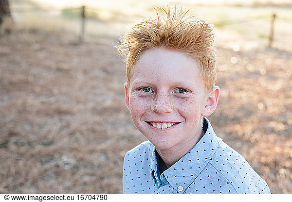 Portrait Of A Happy Freckled Red Haired Boy