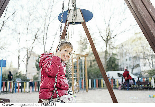 Portrait of a kid in the swing