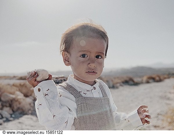 Portrait of a kid looking into camera in the desert