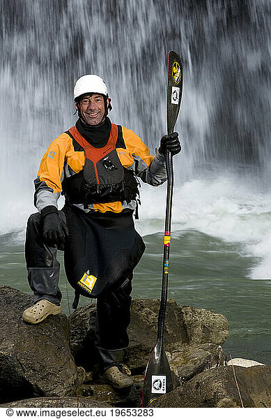 Portrait of a male kayaker in front of a waterfall..