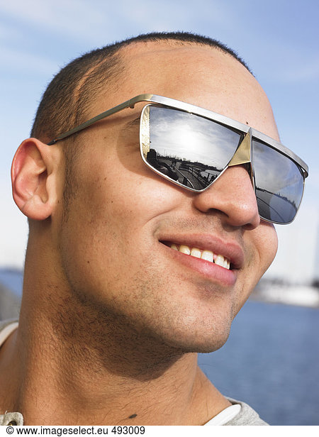 Portrait of a man wearing sun glasses.