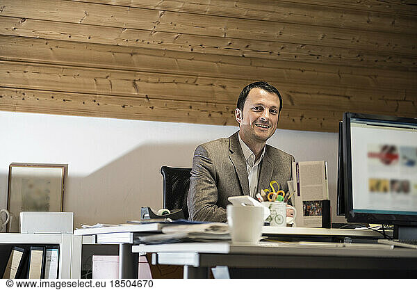 Portrait of a mature businessman working on computer in an office  Bavaria  Germany