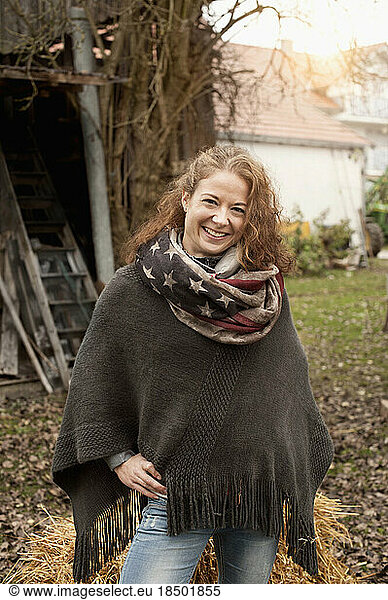 Portrait of a mid adult woman standing in the farm and smiling  Bavaria  Germany