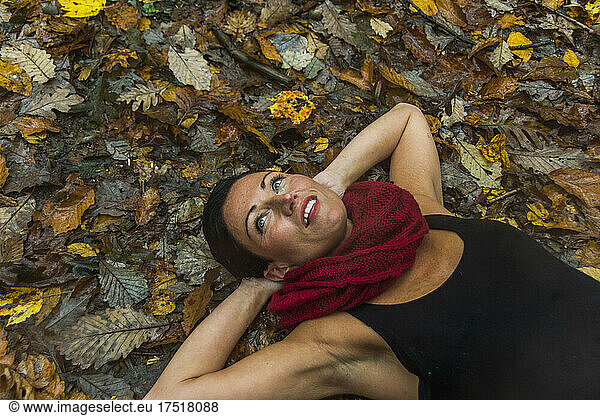 Portrait of a middle aged woman laying in the woods