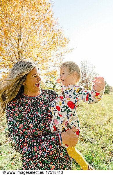 Portrait of a mother and toddler daughter laughing together