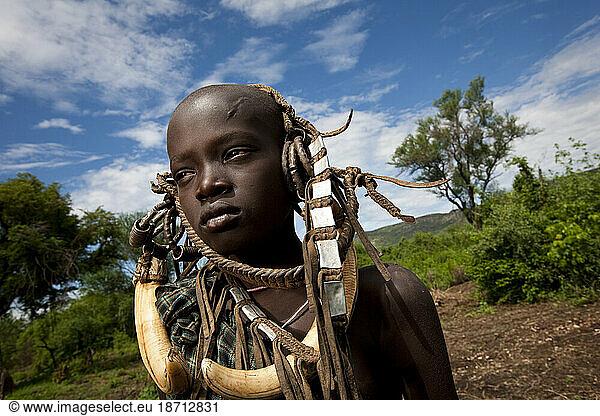 Portrait of a Mursi boy with an ornate head dress  Lower Omo Valley  Ethiopia.