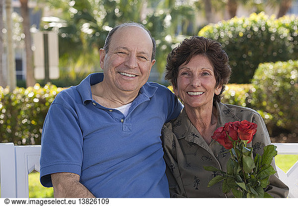 Portrait of a senior couple smiling with a valentine´s rose