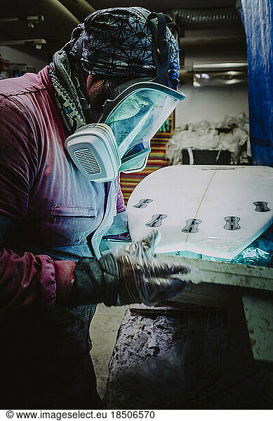 Portrait of a shaper from Tenerife working on a new surfboard