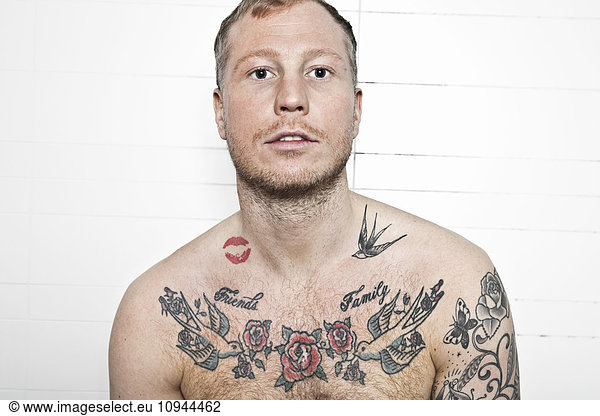 Portrait of a shirtless tattooed man