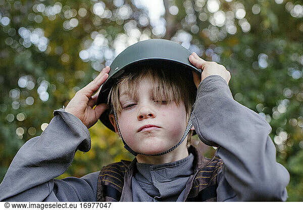 Portrait of a small serious boy wearing a soldier halloween costume