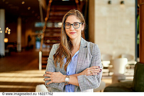 Portrait of a smiling business woman with her arms crossed.