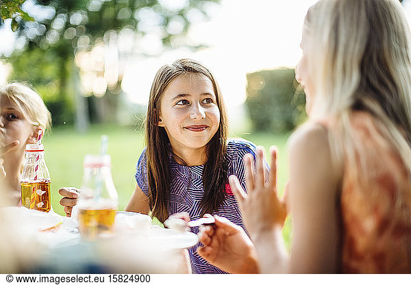 Portrait of a smiling girl on a birthday party outdoors