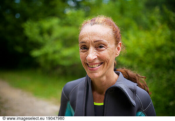 Portrait of a smiling red-haired woman in a wetsuit